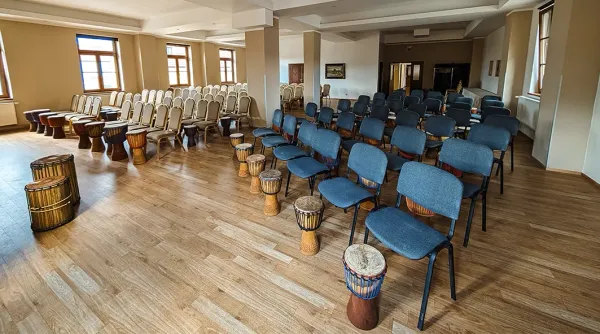 Velký sál s židlemi a bubny připravený na firemní akci